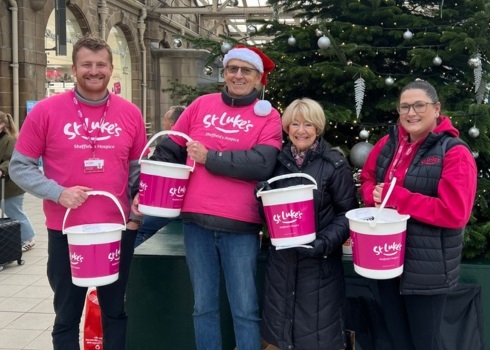 A team of St Luke's collective volunteers in Christmas hats looking festive