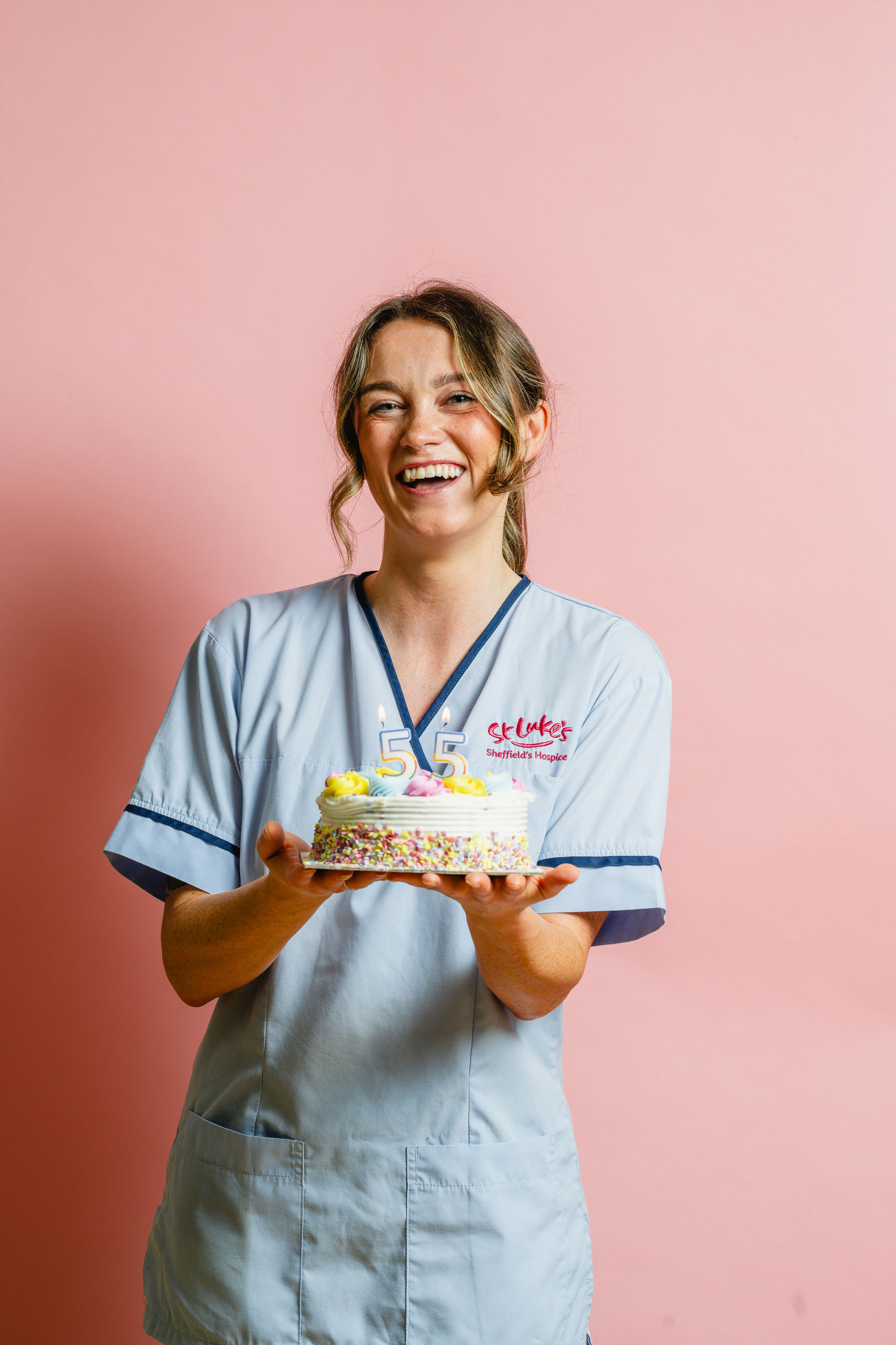 St Luke's nurse holding a Birthday cake